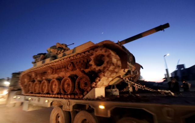 Turkish military vehicles enter the Bal al-Halwa crossing at the Syrian-Turkish border, in Idlib governorate