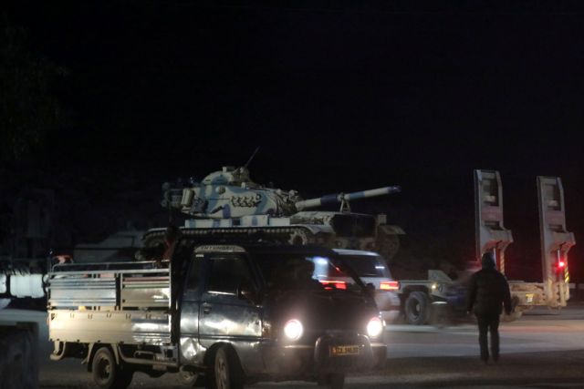 Turkish military vehicles enter the Bab al-Hawa crossing at the Syrian-Turkish border, in Idlib governorate